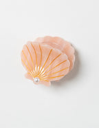 SaltyKurlz ocean claw clip — seashells design in peach